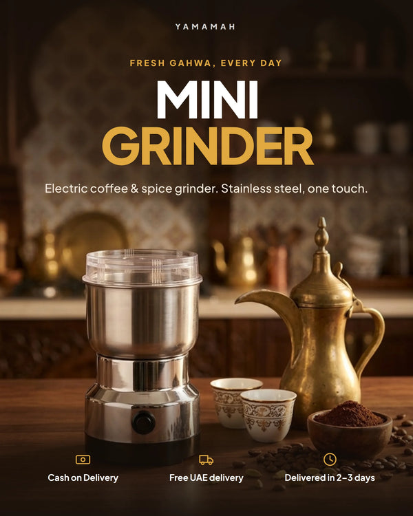 Electric coffee and spice grinder beside a brass dallah and Arabic coffee cups